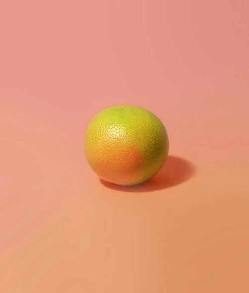 an orange sitting in the middle of a pink background