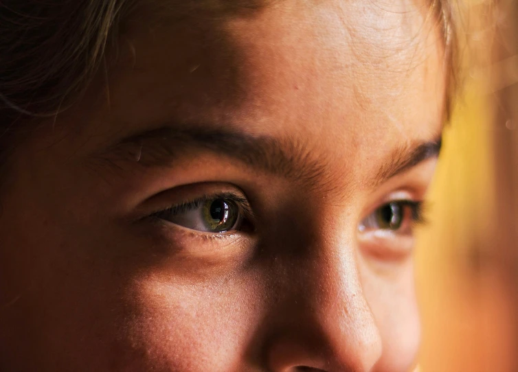 a girl looking off to her left with a black nose