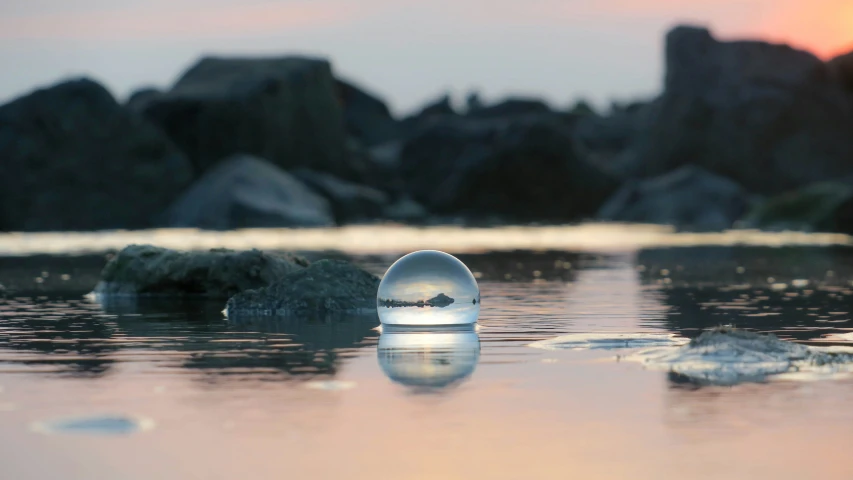 a white piece of glass floating in a lake