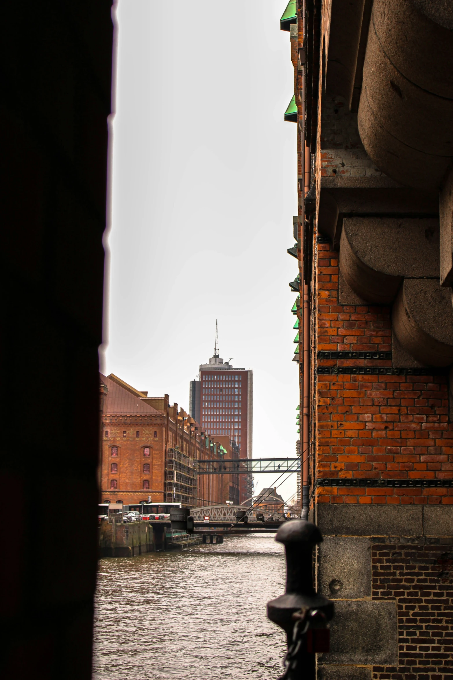 a canal runs alongside brick buildings in a city