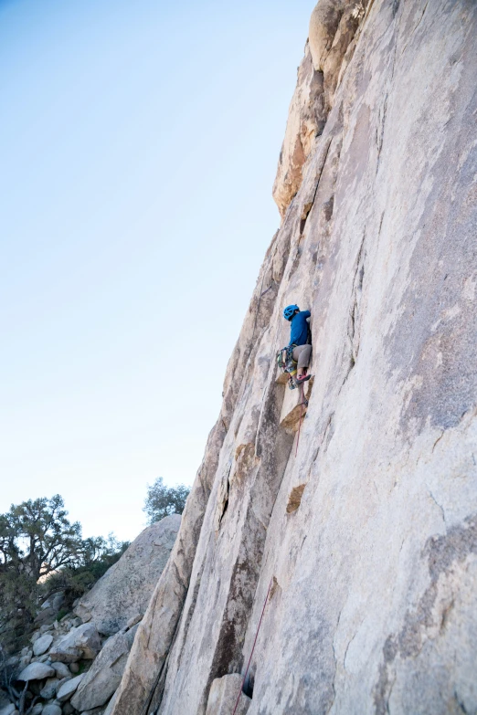 a person is climbing up a large rock