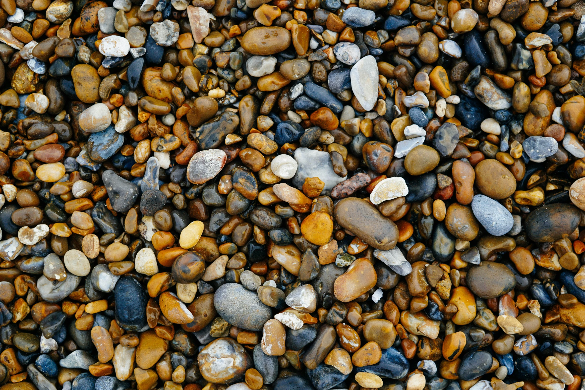 a lot of rocks covered in sand and gravel