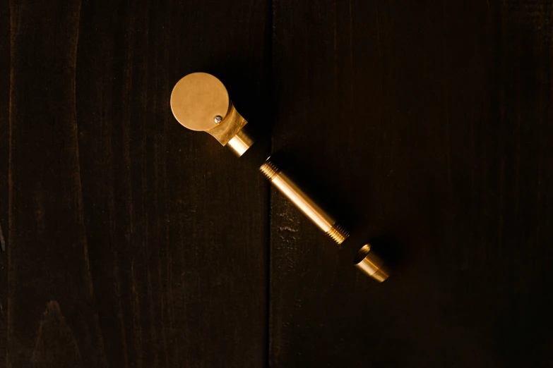 a close up of a door handle on a wooden door