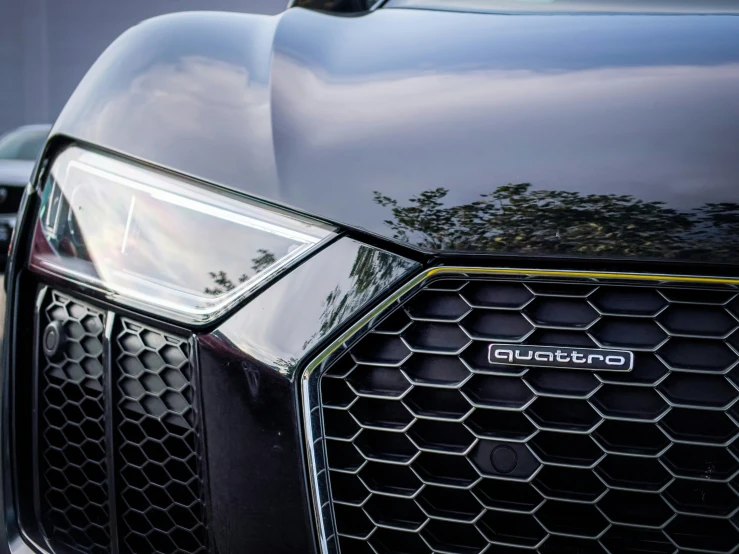 the front end of an audi car with its headlights showing