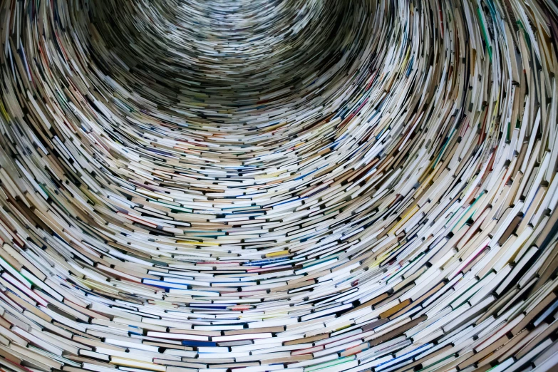 the inside of a spiraled book with bookshelves in the middle