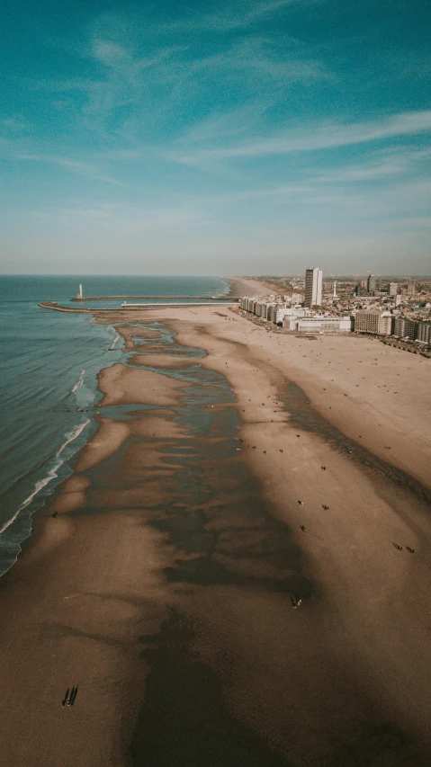 a sandy beach sitting next to the ocean