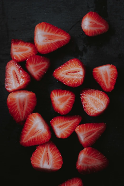 several pieces of strawberries are laying on a table