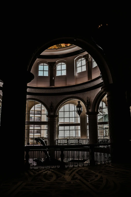 an indoor atrium in a building with windows and pillars