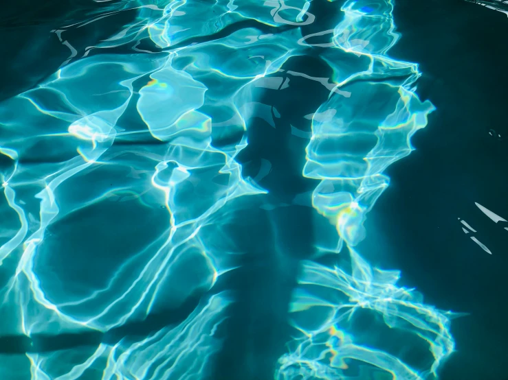 the shadow of a clock against the water