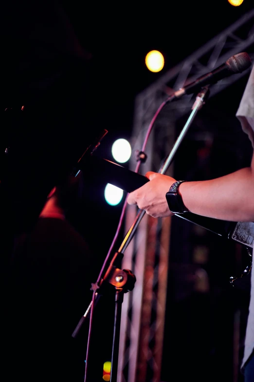 a man on stage holding a guitar