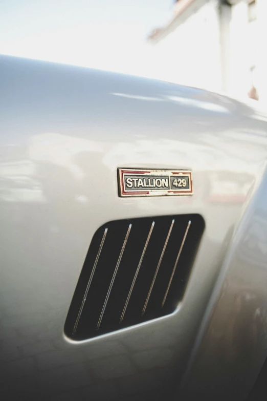 a close up of the grill on a grey car