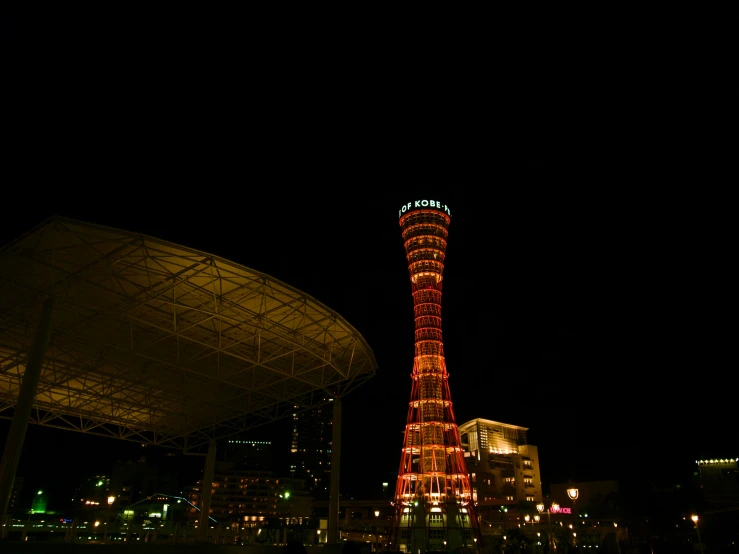 a tall red tower lit up in the night