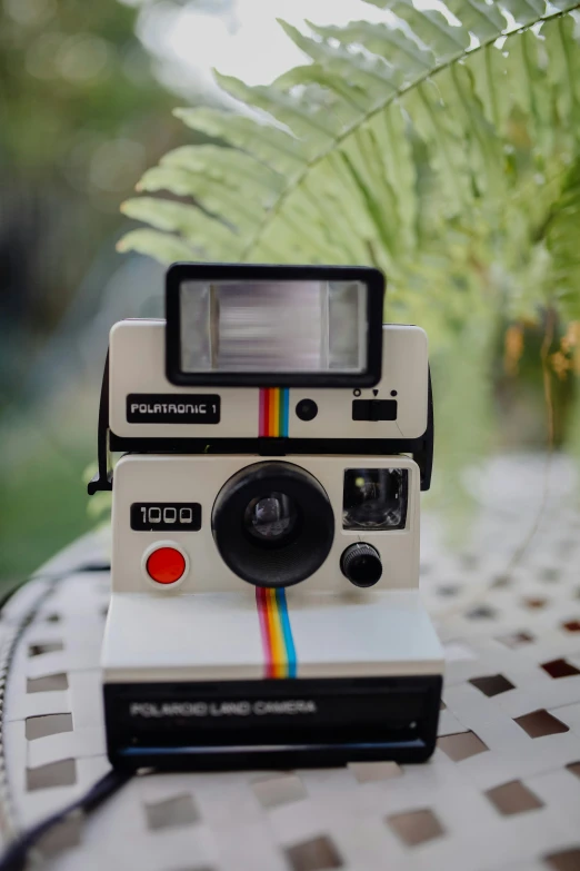 an old camera with the colors rainbow on it