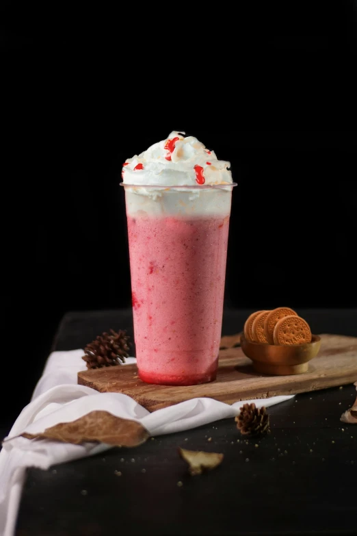 an ice cream smoothie is sitting on top of a wooden plate