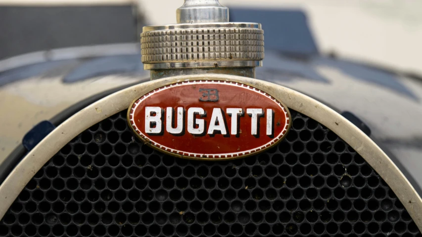 an old - fashioned bugatti type logo is mounted to the front end of the bugatti