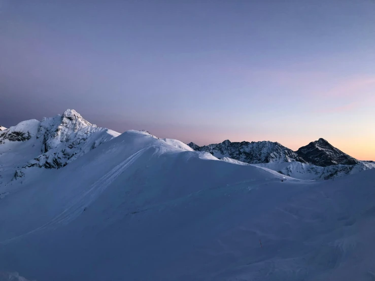 a group of snow skiers on top of a mountain