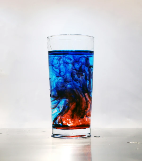 a close up of a blue glass with liquid