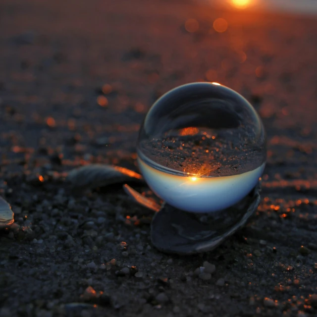 a ball sitting on the ground next to a white object