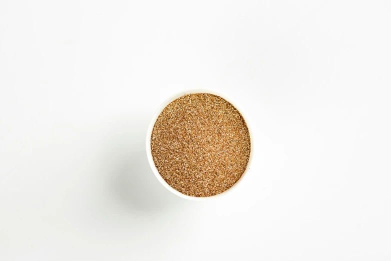 an overhead view of an open bowl of brown color on a white background