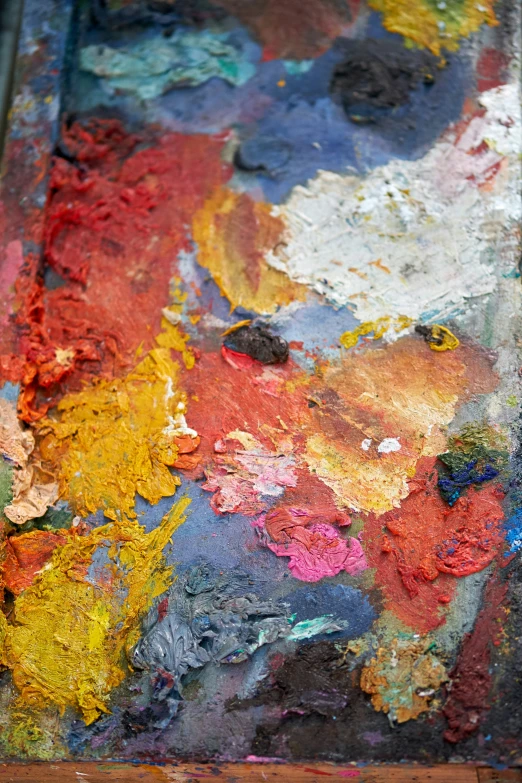 a close - up of the paint on a painting with brushes