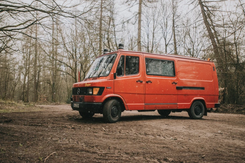 the old van is parked in the mud