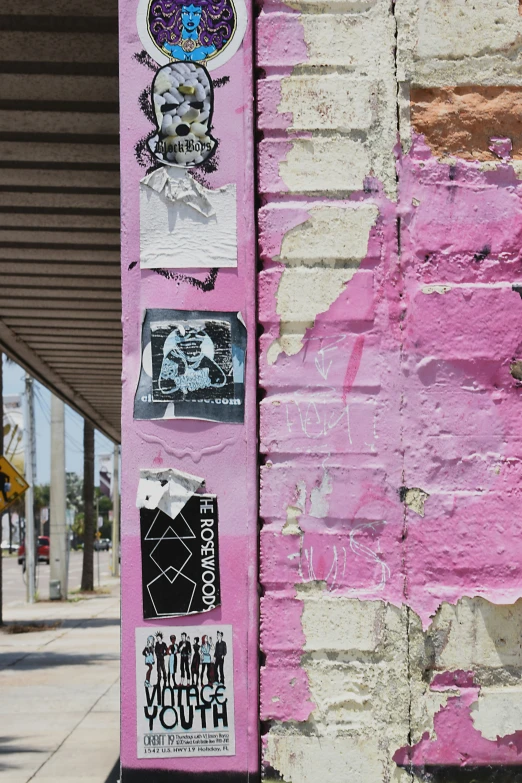 some graffiti is shown on a pink wall