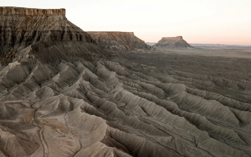 desert like terrain is featured against the sunset