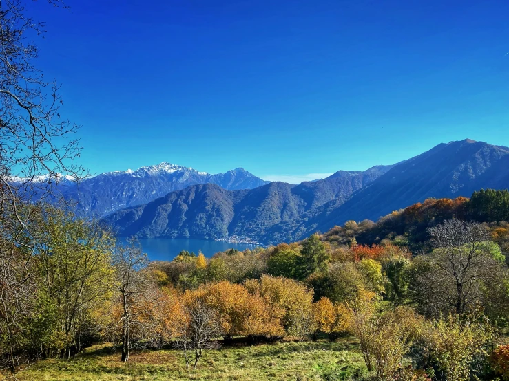 the mountain range has autumn colored trees in them