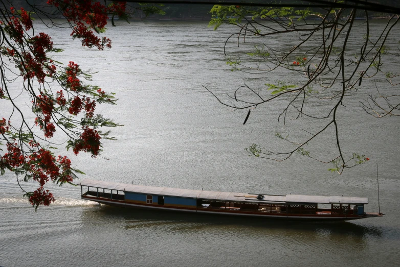 a boat with passengers is sailing on the river