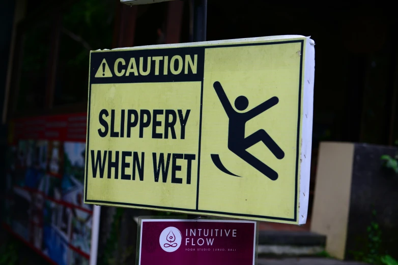 warning sign for slippery water from falling man