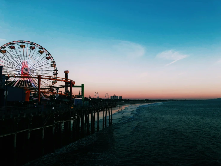 there is an old fashioned ferris wheel on the beach