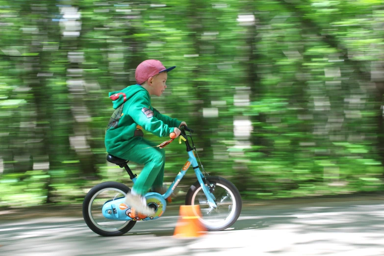 a child riding a bike on the road