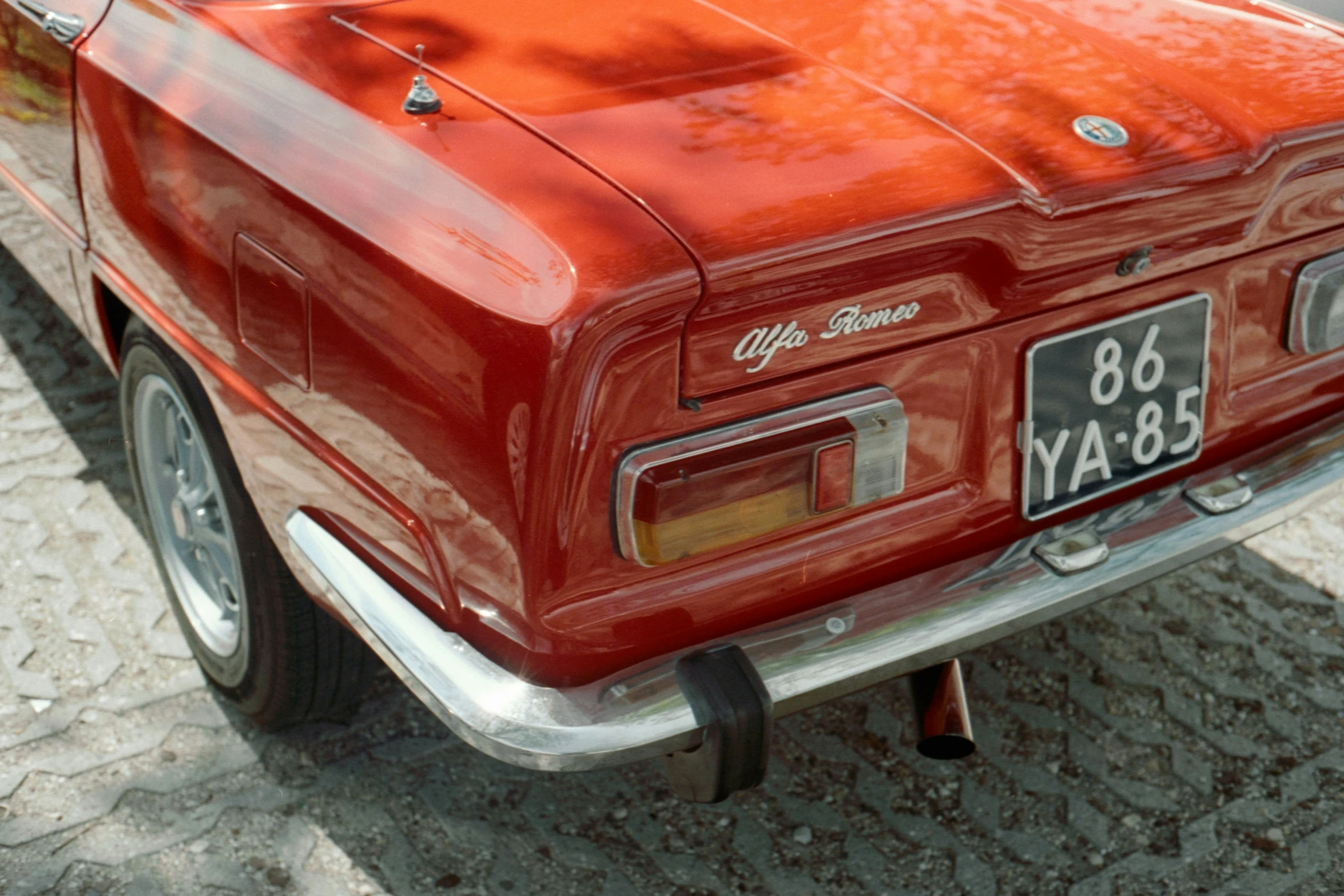 a close up of a red old time looking classic car