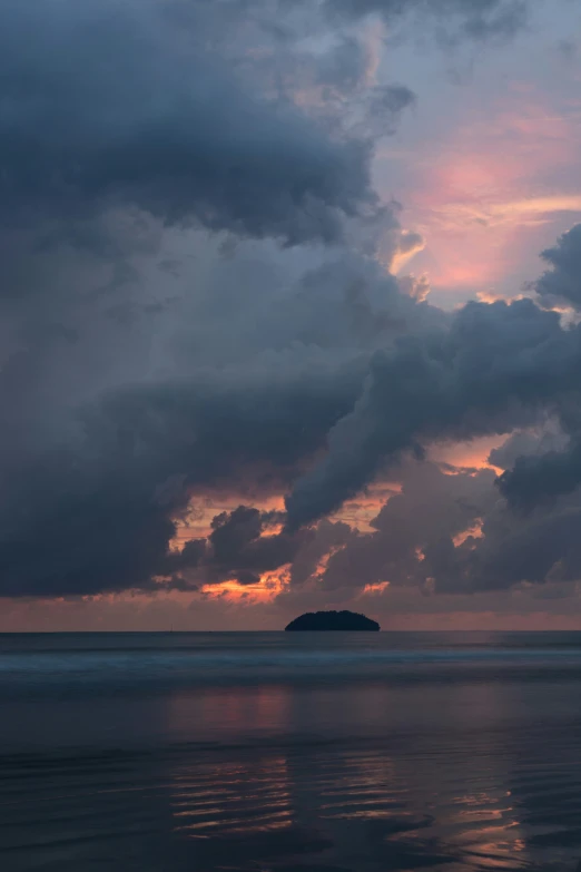 a view of the ocean under cloudy skies