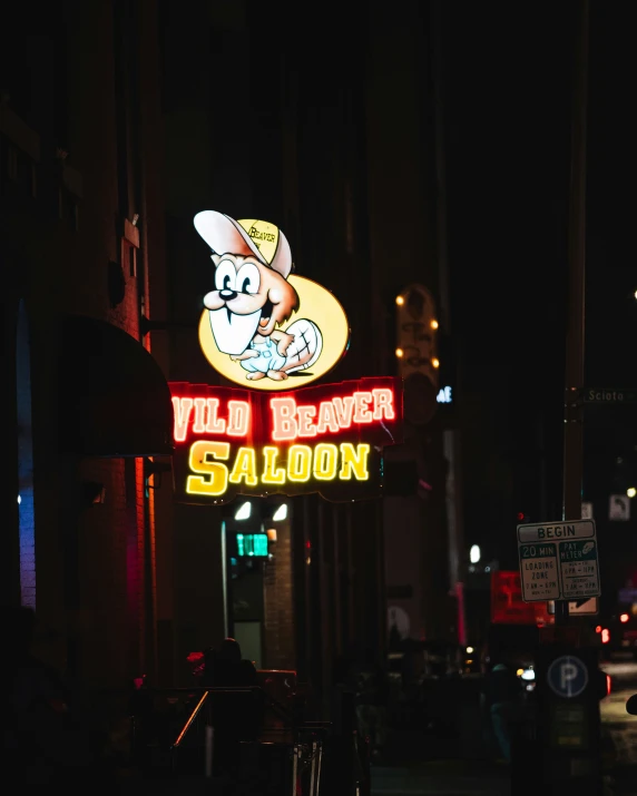 a neon sign for a saloon advertises a cartoon