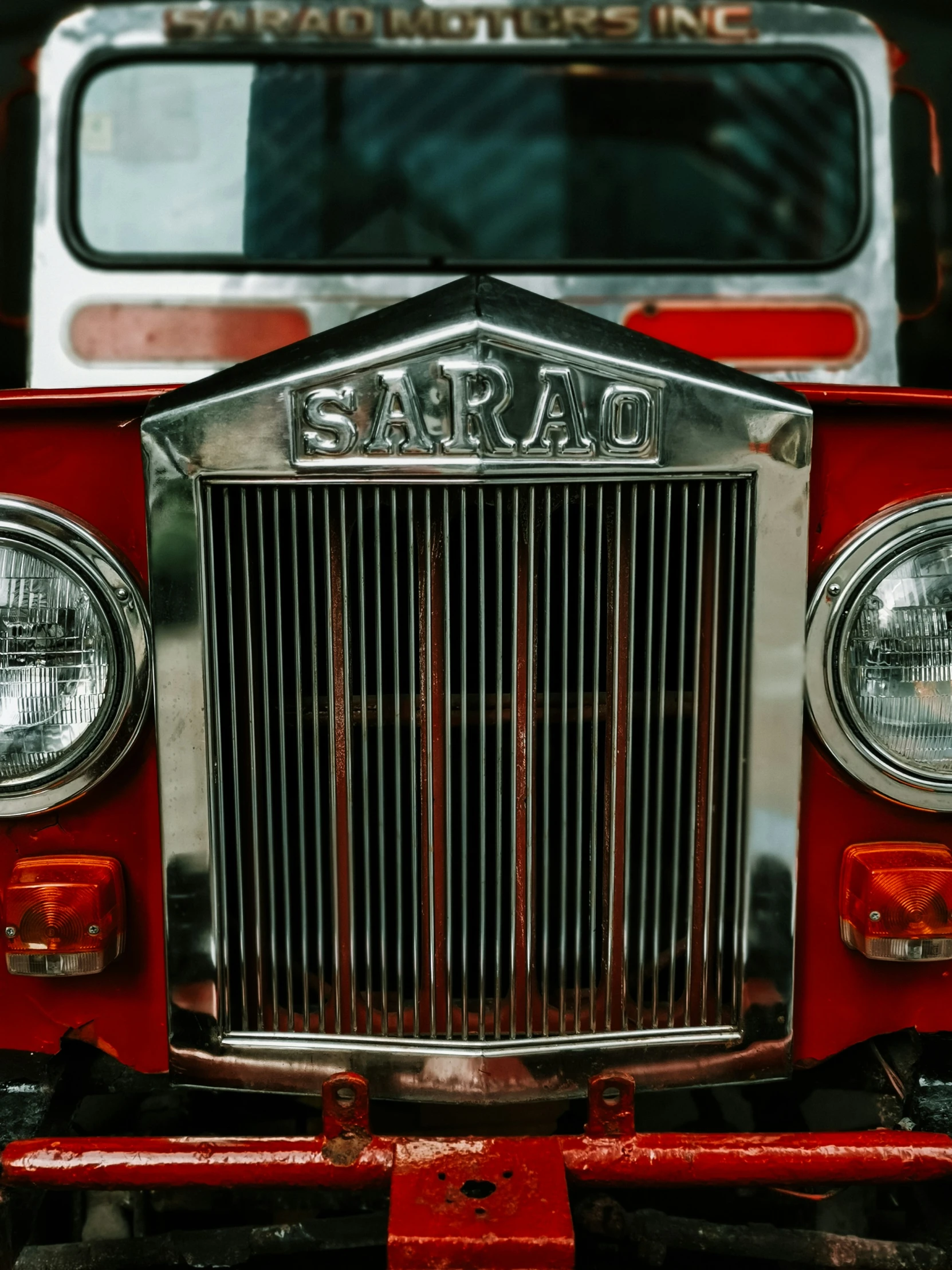 the grills and headlights on an old red truck