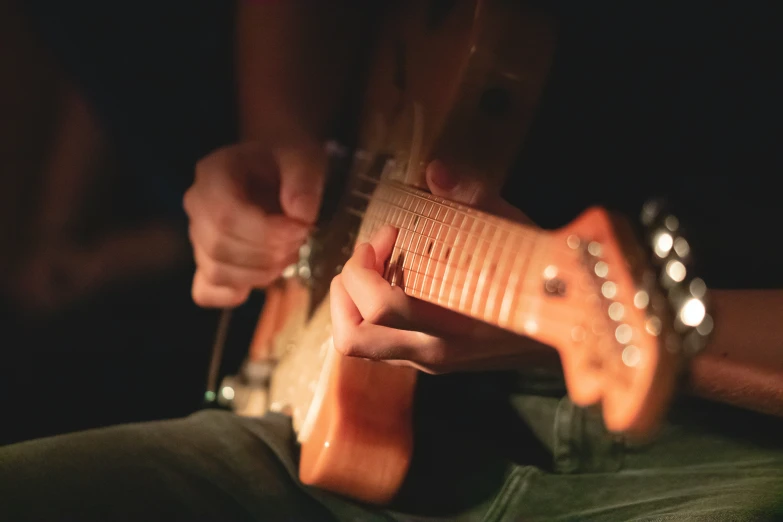 a man playing an instrument in a dark room