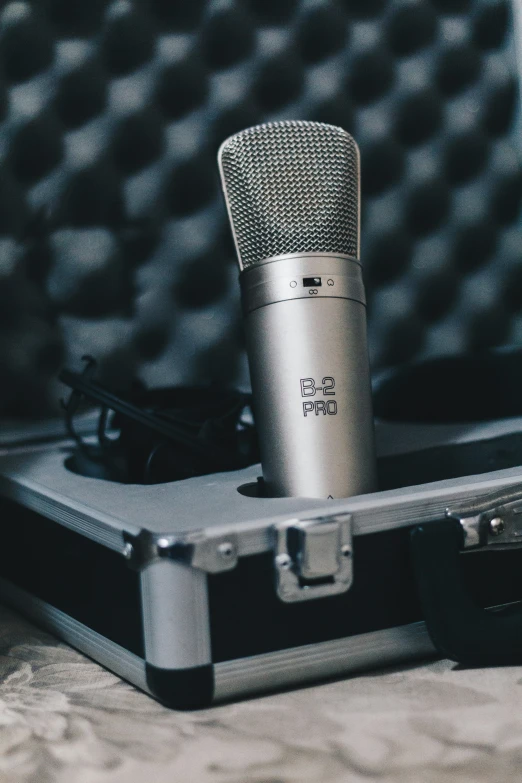 a close up of an old microphone on a piece of luggage