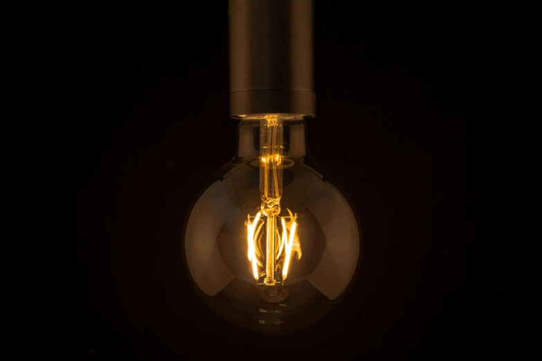 a light bulb turned upside down on a black background