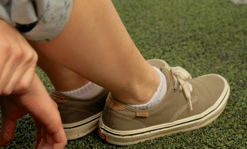 the woman is putting a small red marker on her shoe