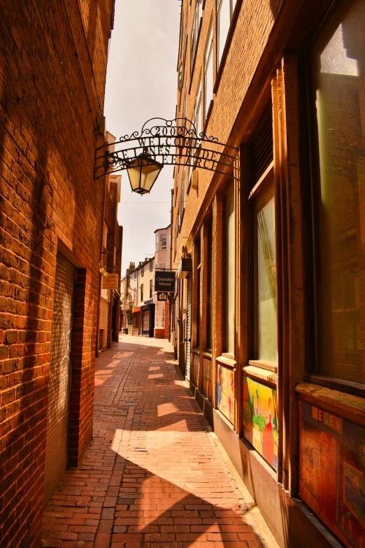 a alley way has signs in front of buildings