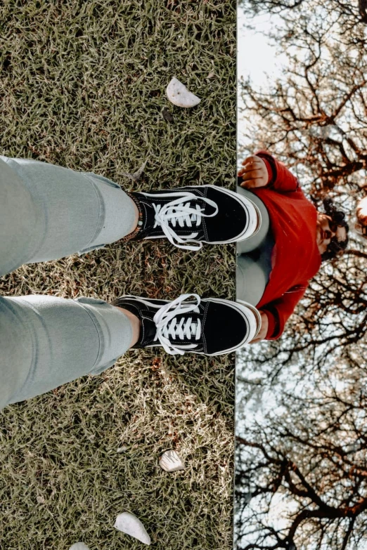 two people wearing tennis shoes and standing in front of a tree