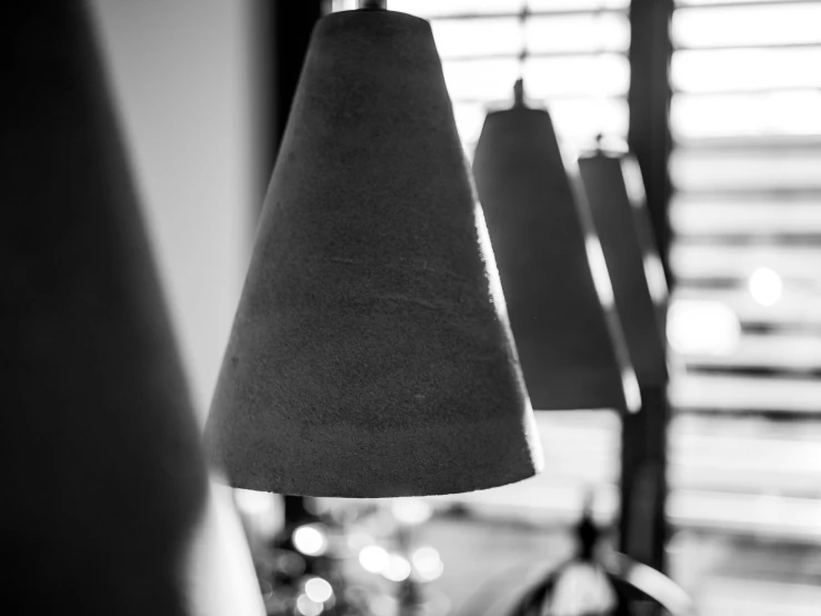 black and white po of three hanging lamps