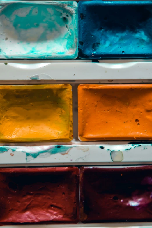 a multicolored painting of glass blocks placed against the wall