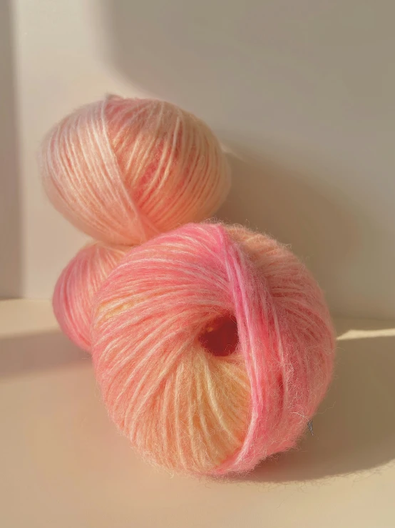 two yarn balls sit together next to each other