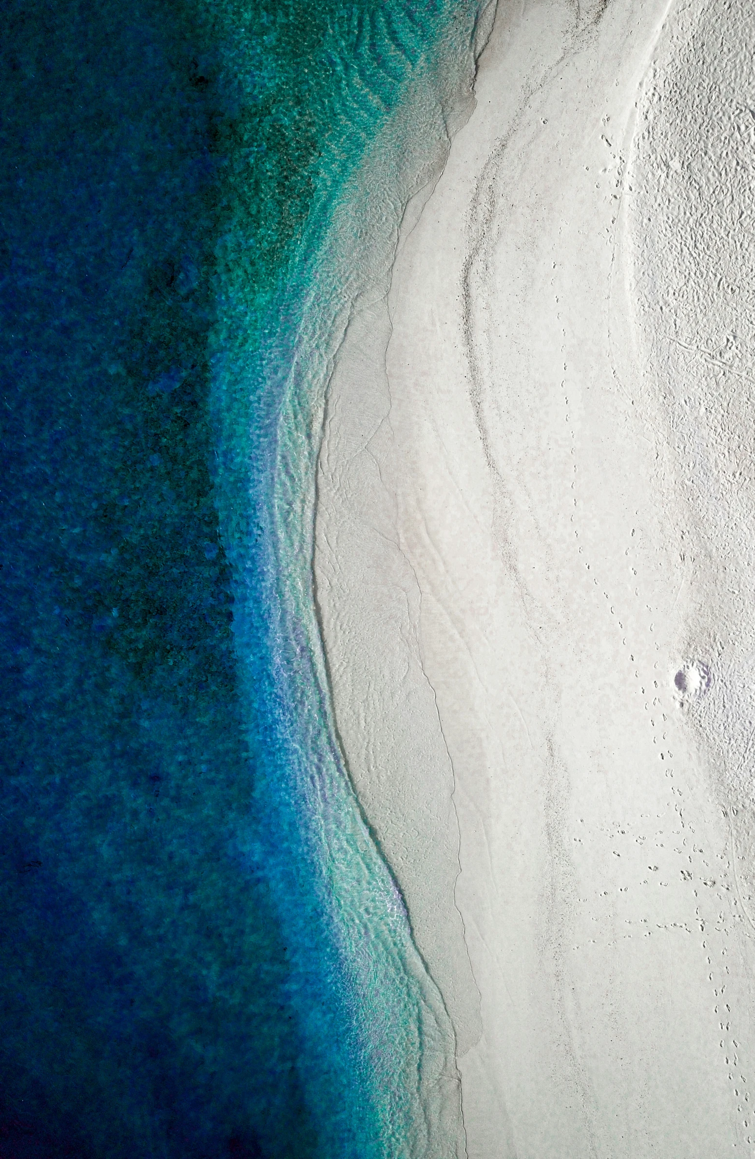 aerial view of sand, water and sand beach