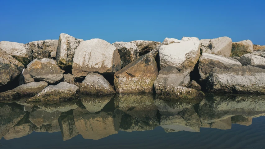 there is a group of rocks that are in the water