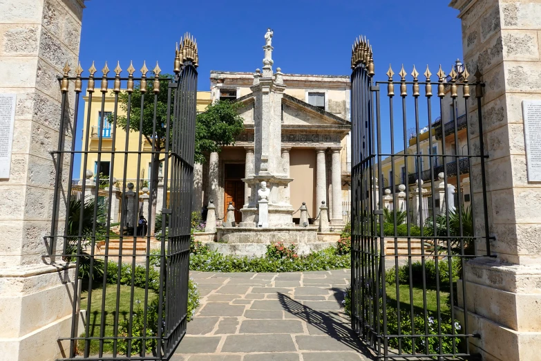 a large house is seen through the gate