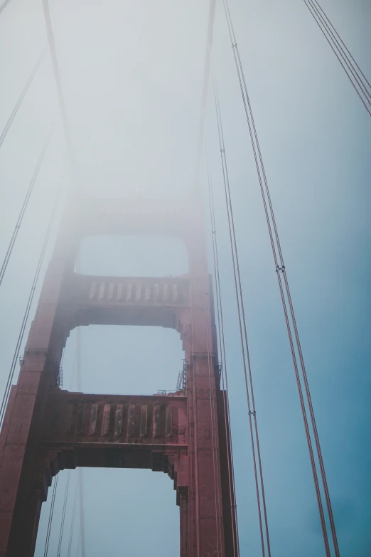 this is a bridge in the fog that looks like it has two lanes to cross