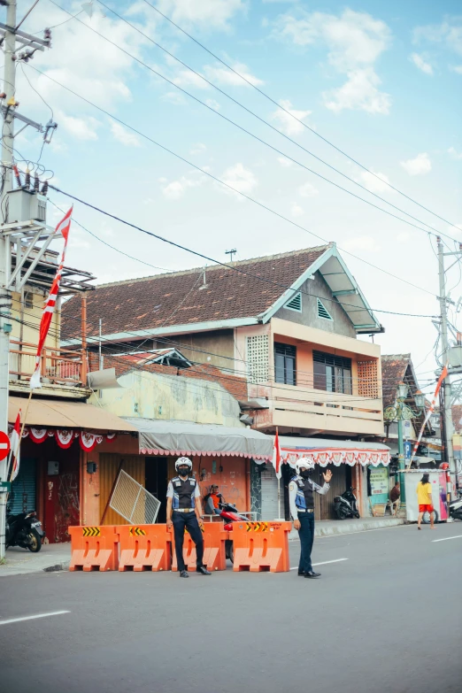 three men stand in front of orange crates outside of an asian - style restaurant